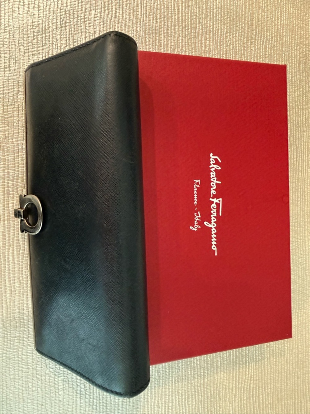 Salvatore Ferragamo Black Leather Turn-Lock Wallet with Silver Details.